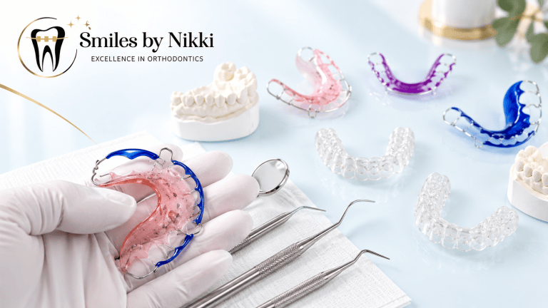 Orthodontic retainers, clear aligners, dental models, and tools displayed at Smiles by Nikki.